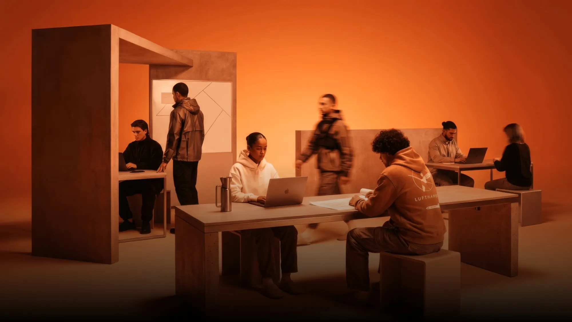 Bárries-Kampagnenmotiv: Team im Büro in warmem Orange
